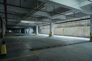 old parking lot with lighting, concrete building photo