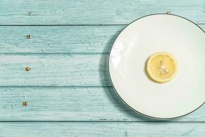 the fruit lemon on the blue table, cool light background photo