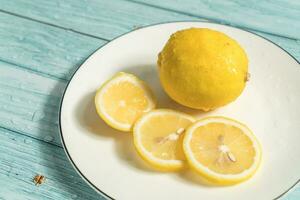 the fruit lemon on the blue table, cool light background photo