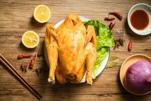 Roast chicken on the wooden table photo