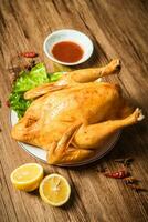 Roast chicken on the wooden table photo