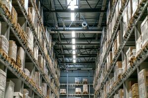 The warehouse full of goods, boxes and shelves photo