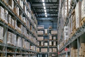 The warehouse full of goods, boxes and shelves photo