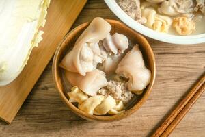 trotter soup with wooden background photo