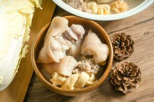 trotter soup with wooden background photo