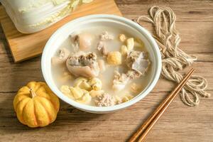 trotter soup with wooden background photo