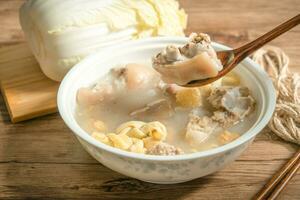 trotter soup with wooden background photo