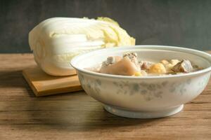 trotter soup with wooden background photo