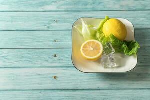 the fruit lemon on the blue table, cool light background photo