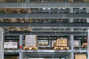 The warehouse full of goods, boxes and shelves photo