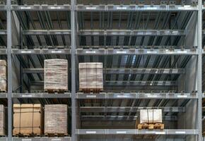 The warehouse full of goods, boxes and shelves photo