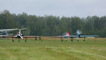 Light engine training aircraft with running engines on the airfield, summer day video