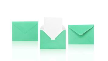 Three green envelopes isolated on white background one open with a note inside. Delivery service. Place for your text. photo