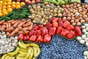 Variety of vegetables and fruits on the stand. Autumn harvest. Grocery rack photo