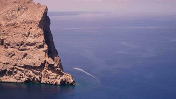 A beautiful huge rock rises above the blue sea video