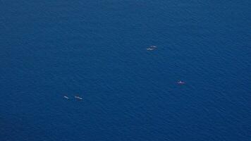 Tourists kayak on the sea video