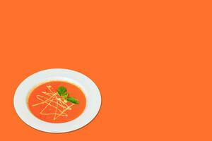 Creamy Tomato soup in a bowl on background. copy space. photo