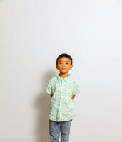 Cute little boy in casual outfit on background photo