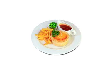 Steak and kidney pie with puff-pastry top and French fries photo