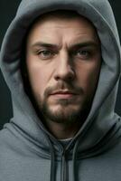 a man in a hoodie with a solid color background photo