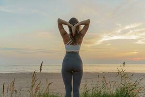 Meditative harmony and balance of a person, mental health. The woman is slender, flexible body, practicing yoga exercise beautiful asana. Fitness on the background of sunset. photo