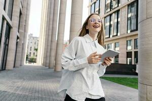 A female student designer uses a tablet for online work. She is leading a new project and is happy with the business. Training online education on the website. photo