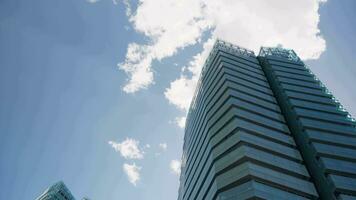 Skyscraper against a blue sky backdrop video