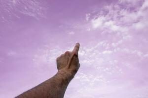 hand up gesturing in the pink sky, feelings and emotions photo