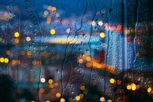 raindrops on the window and Bilbao city background photo