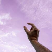 hand up gesturing in the pink sky, feelings and emotions photo