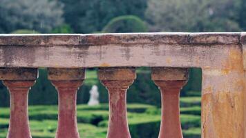 A rainy day in the park, a view of the labyrinth through the balusters. video