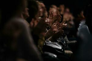 Audience clapping their hands photo