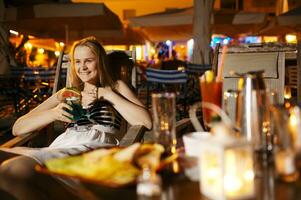 Smiling woman drinking in a cafeteria photo