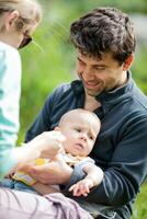 Mom and dad caring for baby photo