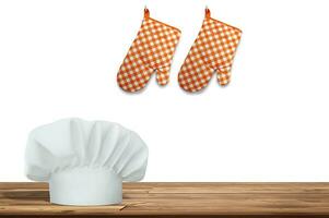 Wooden table with empty space and chef's hat and gloves photo