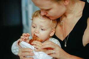 Feeding a baby with pastry photo