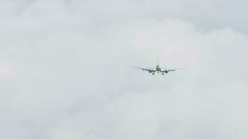 Jet airplane released landing gear. Passenger airliner landing down, front view, haze from hot weather video