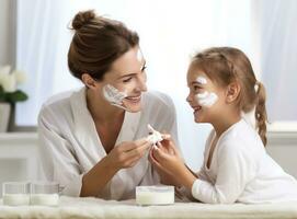 A woman and daughter doing face cream photo