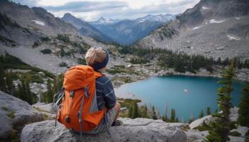 One person hiking mountain peak, exploring nature beauty in Alberta generated by AI photo