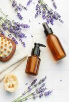 Lavender spa. Lavender salt, natural essential oil, massage brushes and fresh lavender photo