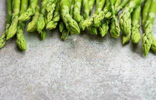 Fresh green asparagus on  concrete background. photo