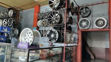 The atmosphere of a shop that sells car tires, wheels and spare parts stored in a window. Can be used for automotive promotions photo