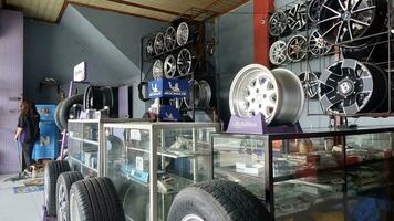 The atmosphere of a shop that sells car tires, wheels and spare parts stored in a window. Can be used for automotive promotions photo