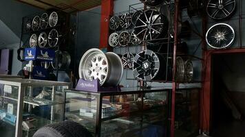 The atmosphere of a shop that sells car tires, wheels and spare parts stored in a window. Can be used for automotive promotions photo