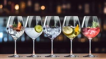 Colorful gin tonic cocktails in wine glasses on bar counter in pup or restaurant. photo