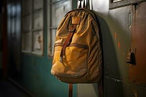 a brown backpack hanging on a wall photo