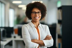 Happy middle aged business afro woman ceo standing in office arms crossed. photo