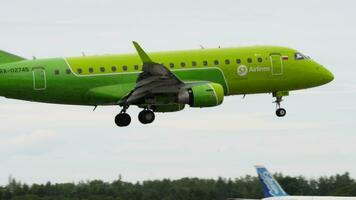 NOVOSIBIRSK, RUSSIAN FEDERATION JULY 15, 2022 - Side view of passenger jet plane embraer E170 of S7 Airlines landing. Airplane flies. Tourism and travel concept video