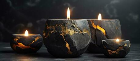 Abstract smudges and cracks adorn a set of stone candle holders featuring a golden flame amidst black concrete with a slightly blurred foreground photo