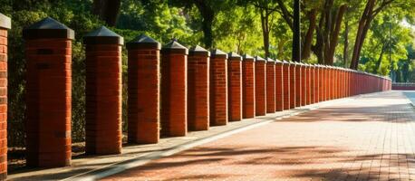 Red brick fence with modern decorative columns photo